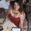 Achi sketching tattoo flash on an iPad